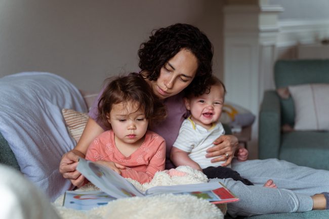 Mom enjoying relaxing morning at home with sleepy and happy kids